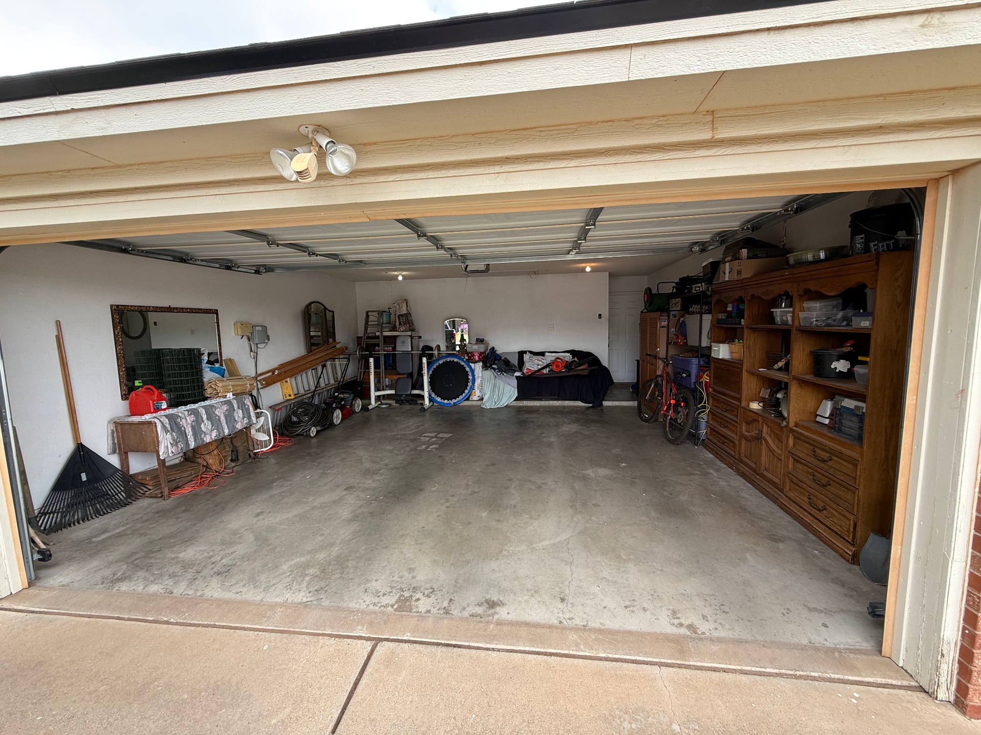 Cluttered Lubbock garage before Timmy's Garage cleanout